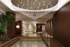 a hallway with a large chandelier in a hotel at Nemu Resort Hotel Nemu in Shima