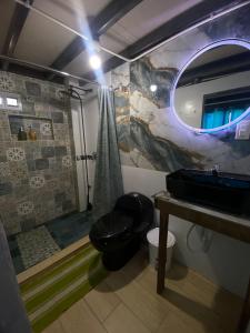 a bathroom with a shower and a toilet and a mirror at MARIBAO in Playas