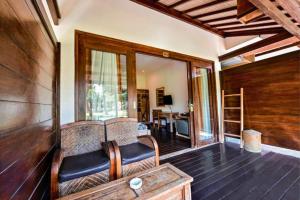 a living room with a couch and a table at Sidesratra 1 BR Classic Superior NE56 in Gili Islands