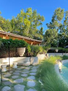 a garden with a bath tub and a swimming pool at Nusava Boutique Hotel in Nusa Penida