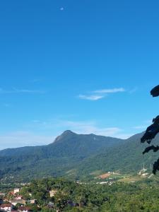 a view of a valley with mountains in the background at Casa temporada Ilhabela in Ilhabela