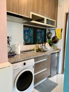 a kitchen with a washing machine in a kitchen at Sea view 2 bedroom Fully furnished Apartment Forest City Starview Bay Johor Malaysia in Kampong Pok Kechil