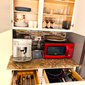 a kitchen with a microwave and a coffee maker at Fully Equipped Cozy 4/5 BR in Chicago
