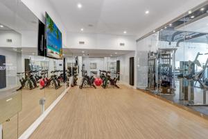 a gym with a bunch of bikes in a room at Downtown Tampa Gem 1-BD w/Pool, Gym, & Sky Lounge in Tampa