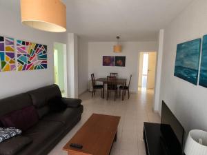 a living room with a couch and a table at Blue House in Las Palmas de Gran Canaria