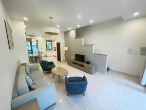 a living room with a couch and chairs and a table at Royal Lotus Homestay Villa 5 Phòng Ngủ in Ha Long