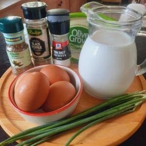 a wooden cutting board with eggs and green onions and milk at Hug Doi Homestay in Ban Wo +21 photos