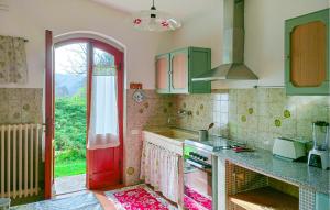 a kitchen with green cabinets and a red door at Casa Ciricea in Piteccio