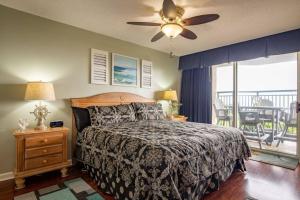 a bedroom with a bed and a ceiling fan at Windy Hill Dunes 104 condo in Myrtle Beach