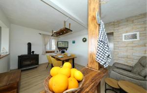 a living room with a bowl of fruit on a table at 4 Bedroom Amazing Home In Banj in Banj