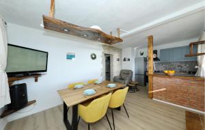 a dining room with a wooden table and yellow chairs at 4 Bedroom Amazing Home In Banj in Banj