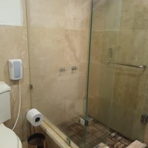 a shower with a glass door in a bathroom at Casa Catalina in Antigua Guatemala