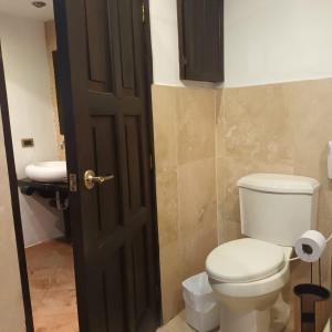 a bathroom with a toilet and a sink at Casa Catalina in Antigua Guatemala