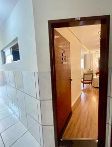a hallway with a door and a living room at Apartamento próximo ao Parque do Povo em Campina Grande in Campina Grande