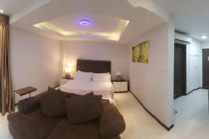 a living room with a bed and a couch at Sheryll Escapes - 214 La Grande Studio, comfy hotel amenities with Netflix! in Angeles +15 photos