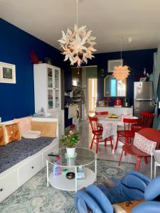 a living room with blue walls and a dining room at Colorful Seaview apartment Forestcity Johor Bahru Malaysia in Gelang Patah