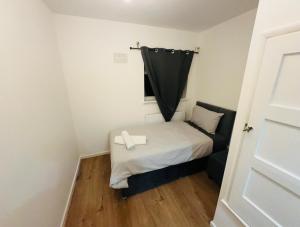a small room with a bed and a window at 9 probyn close in Bristol