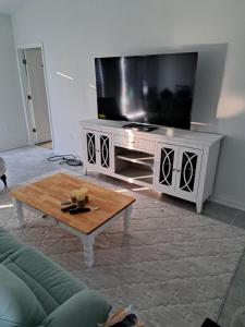 Coastal retreat- monthly stay في إدج ووتر: غرفة معيشة مع تلفزيون وطاولة قهوة