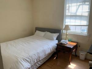 um quarto com uma cama e uma mesa com um candeeiro em 2131 em Filadélfia