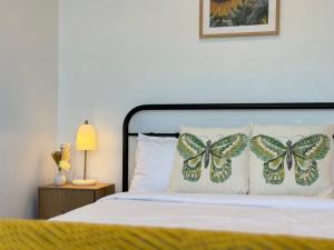 a bedroom with a bed with butterfly pillows on it at Convenient 2 Bedroom house unit in Salisbury in Brisbane