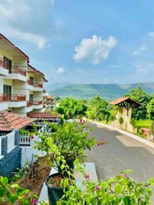 a view from the balcony of a resort at Dreamview Mountains - Cozy 1bhk with Sunrise view in Karjat