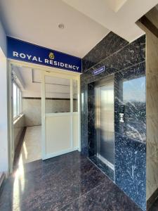 RāmanagaramにあるRoyal Residencyの王室の看板が壁に貼られたホテルのロビー