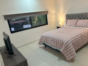 Tempat tidur dalam kamar di Casa completamente amueblada MdA