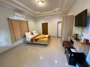 1 dormitorio con 1 cama y TV en Brown Andaman Krabi en Krabi