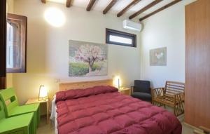 a bedroom with a large red bed in a room at 2 Bedroom Lovely Home In Noto in Noto