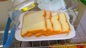 a plastic container with slices of bread on a plate at Fall Asleep hotel in Nonthaburi +14 photos