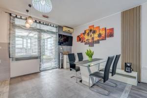 a dining room with a table and chairs at Apartment Slavica-New-With Jacuzzi in Split