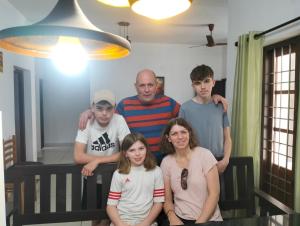 a family poses for a picture in their home at Bachan's Casa in Cherai Beach