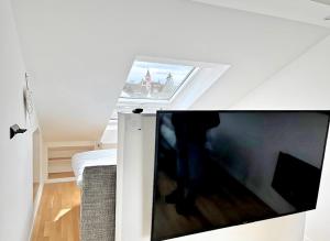a living room with a large flat screen tv at Pension zum Ahrblick in Sinzig