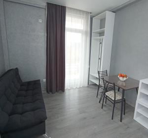 a living room with a table and a couch at Studio in Chakvi in Chakvi