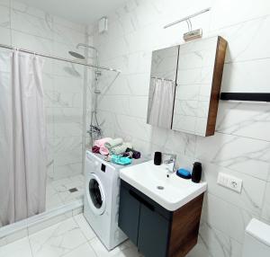 a bathroom with a washing machine and a sink at Studio in Chakvi in Chakvi