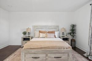 a bedroom with a large bed with two night stands at Newly Renovated Modern Farmhouse in Culpeper
