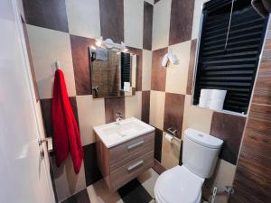 a bathroom with a white toilet and a sink at Room 1 Salina Seaview Retreat in Naxxar