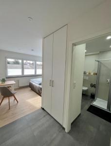 a bedroom with a bed and a sliding glass door at Pension zum Ahrblick in Sinzig