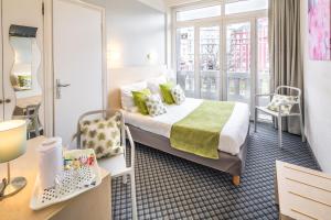 a hotel room with a bed and a window at Hôtel Notre Dame de France in Lourdes