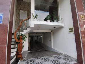 a hallway of a building with stairs and plants at Cát Tâm Hotel in Quy Nhon