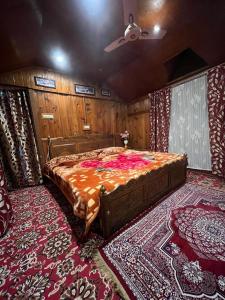 a bedroom with a large bed in a room at Houseboat wild rose in Srinagar