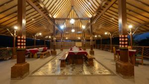 a large pavilion with tables and chairs in it at The Bali Menjangan Boutique Villas & Dive Center in Pemuteran