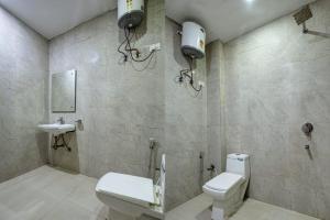 a bathroom with a toilet and a sink at Hotel IVY Near IGI Delhi Airport in New Delhi