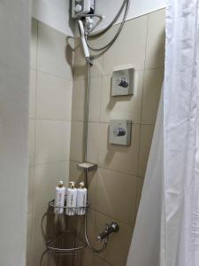 a bathroom with a shower with a shower head at My Humble Abode at Shore 3 in Manila