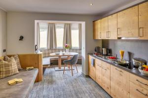 a kitchen with a table and a dining room at Apparthotel Talhof, Restaurant, Pool und Spa in Oberau