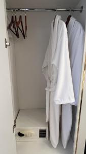 a closet with white towels hanging on a rack at Hotel Panorama in Dushanbe