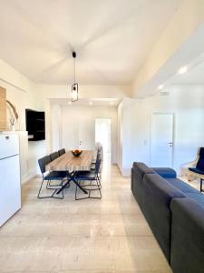 a kitchen and a dining room with a table and chairs at Yela apartment in Malia +13 photos