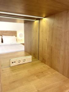 a small bedroom with a bed and a mirror at Yela apartment in Malia