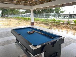 a pool table sitting on top of a patio at Ocean Cottage 2, Radiant Teluk Sari in Kampung Mawar