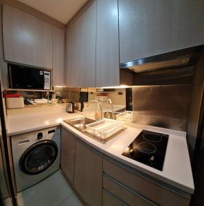 a kitchen with a sink and a dishwasher at 1BR Thonglor , Fast WiFi , Near Samitivej , Nightlife in Khlong Toei